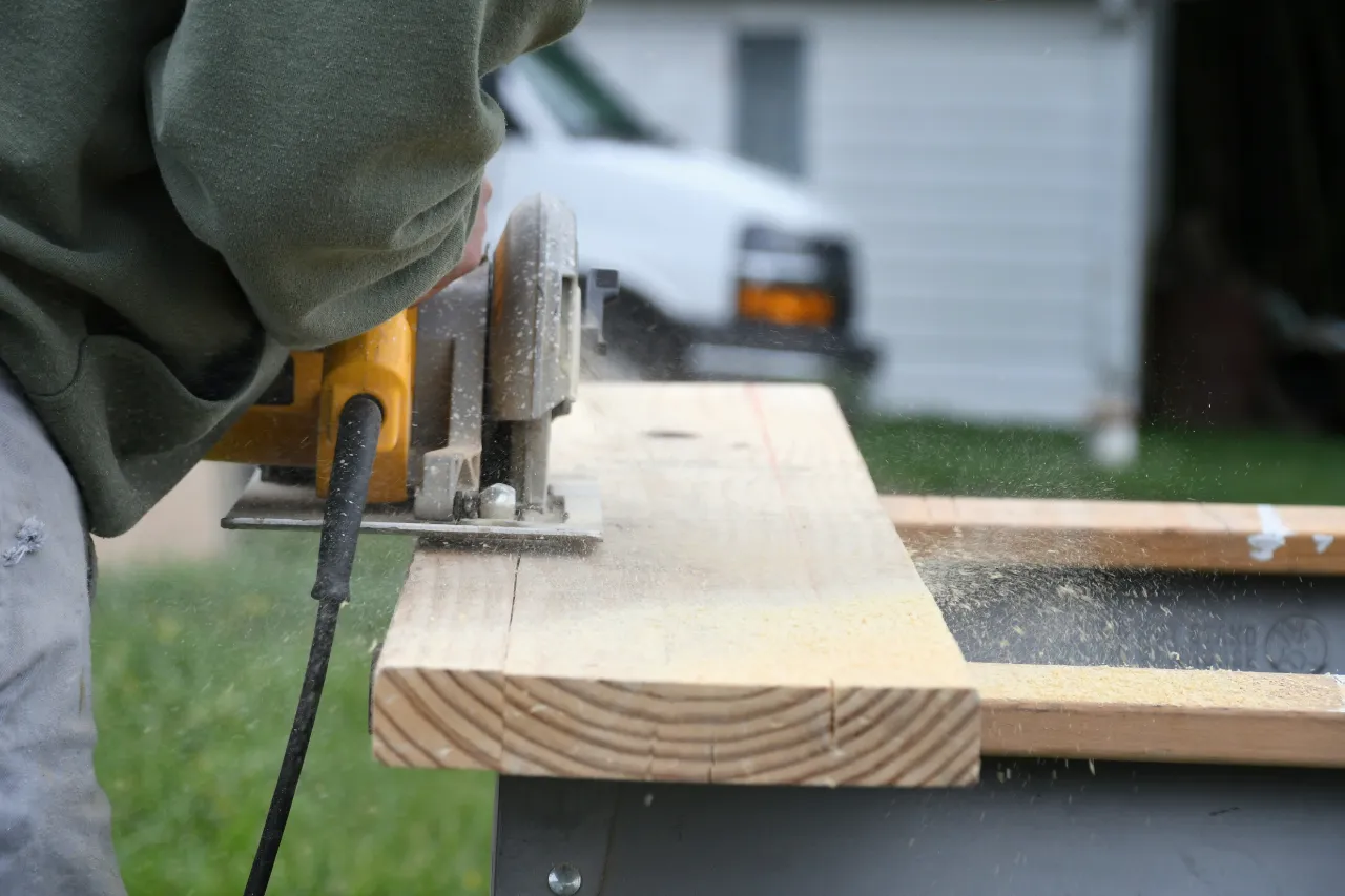 Cutting wood for deck construction outdoors